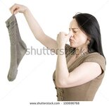 stock-photo-woman-with-dirty-sock-holding-her-nose-on-a-white-background-100696768.jpg