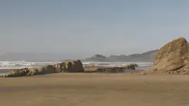 JUMP OFF JOE ROCK YAQUINA LIGHT HOUSE IN THE DISTANCE.webp