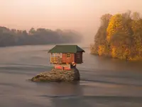 little-house-on-rock-in-the-middle-of-a-river-in-serbia.webp