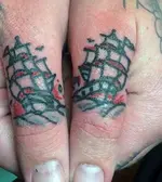 red-and-blue-sailing-ship-men-finger-tattoo.webp