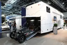 22034238-DUSSELDORF-SEPTEMBER-4-ACE-Cycle-Car-in-a-garage-of-a-large-RV-at-the-Caravan-Salon-...webp