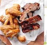 chicken-wings-pork-ribs-juicy-barbeque-dry-glaze-hot-sauce-side-62607647.webp