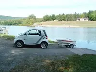 smart-car-with-towing-tiny-boat.webp