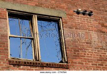 window-frame-and-electrical-insulators-remain-on-brick-building-wall-ctn7m4.jpg