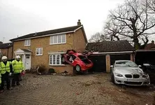 car-stuck-in-brick-house-off-the-ground.webp