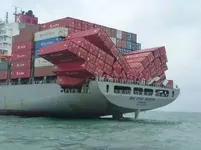 shipping-containers-fallen-over-on-cargo-ship-deck.webp