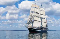 clipper-ship-in-front-of-cloudy-sky.webp