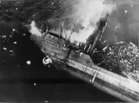 Japanese_crew_going_over_side_as_Kitsugawa_Maru_sinks_at_Apra_Harbor_1944.webp