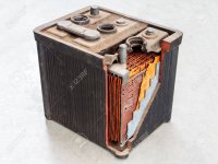 old-car-battery-with-partly-opened-body-on-a-light-grey-background.jpg