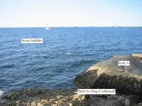 2 divers bubbles beside rock A_1.webp