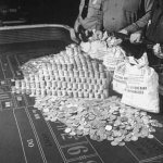 john-florea-police-guarding-500-000-in-silver-being-used-during-a-wwii-war-bond-rally-in-a-gamb.jpeg