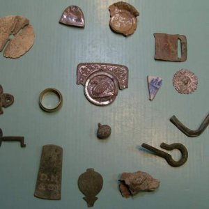 My favorite relics of 2009.   - From the 8 o'clock position, going clockwise: a small clock or cupboard key, an early brass furniture decoration, the 