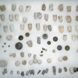 frame of Minie balls, various rifle and pistol lead balls, buttons, insignia, most from Alexandria VA found 1972-3 including one "nipple protector" mi