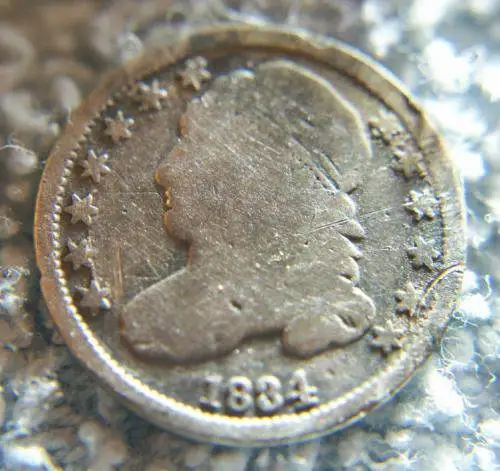 1834 Capped Bust Dime - Found this Capped Bust Dime in a farm field Feb 2011 it was 4 to 5" deep
The site where it was found was a former town that wa