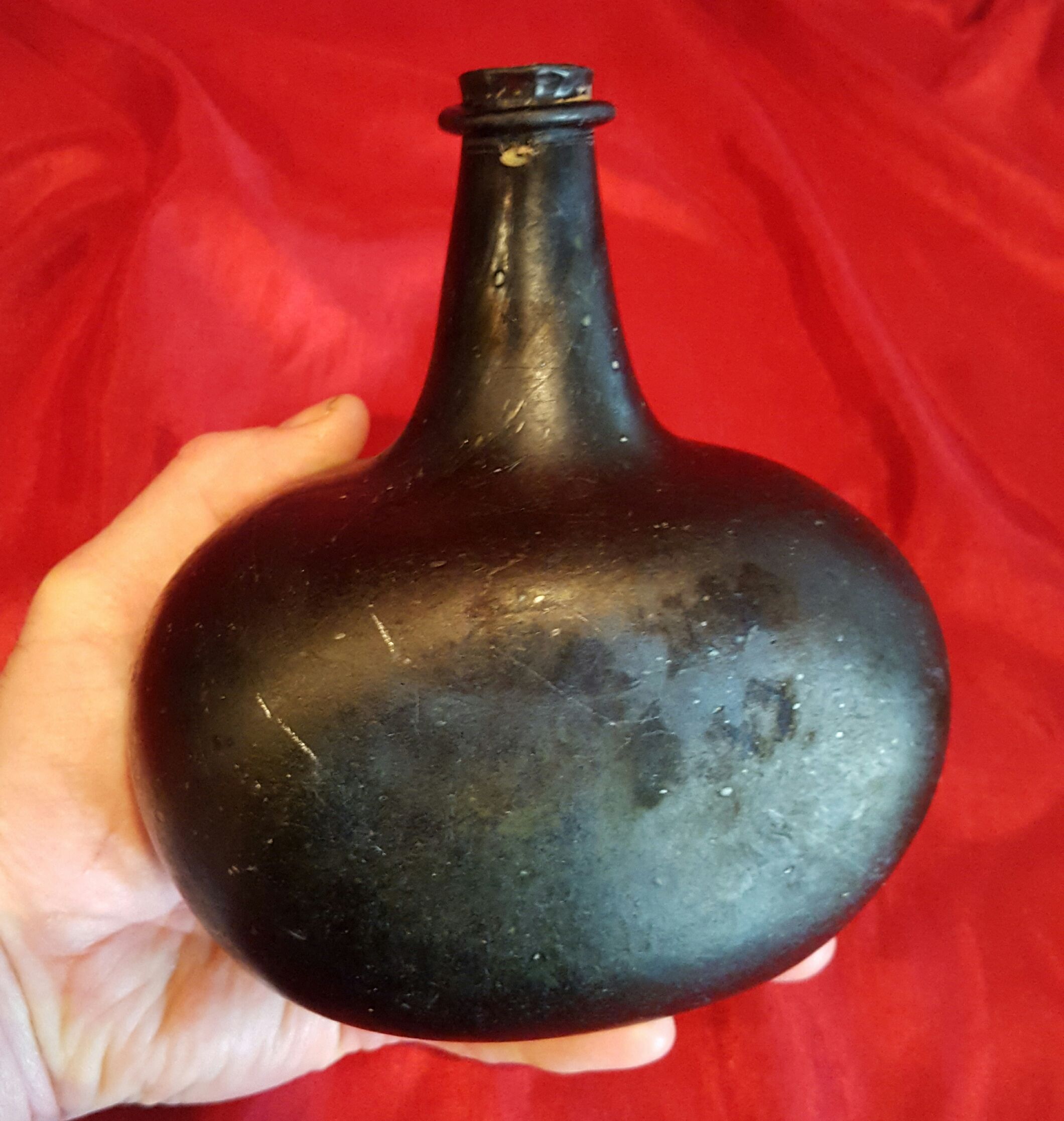 18th century black glass liquor/wine bottle with flat front