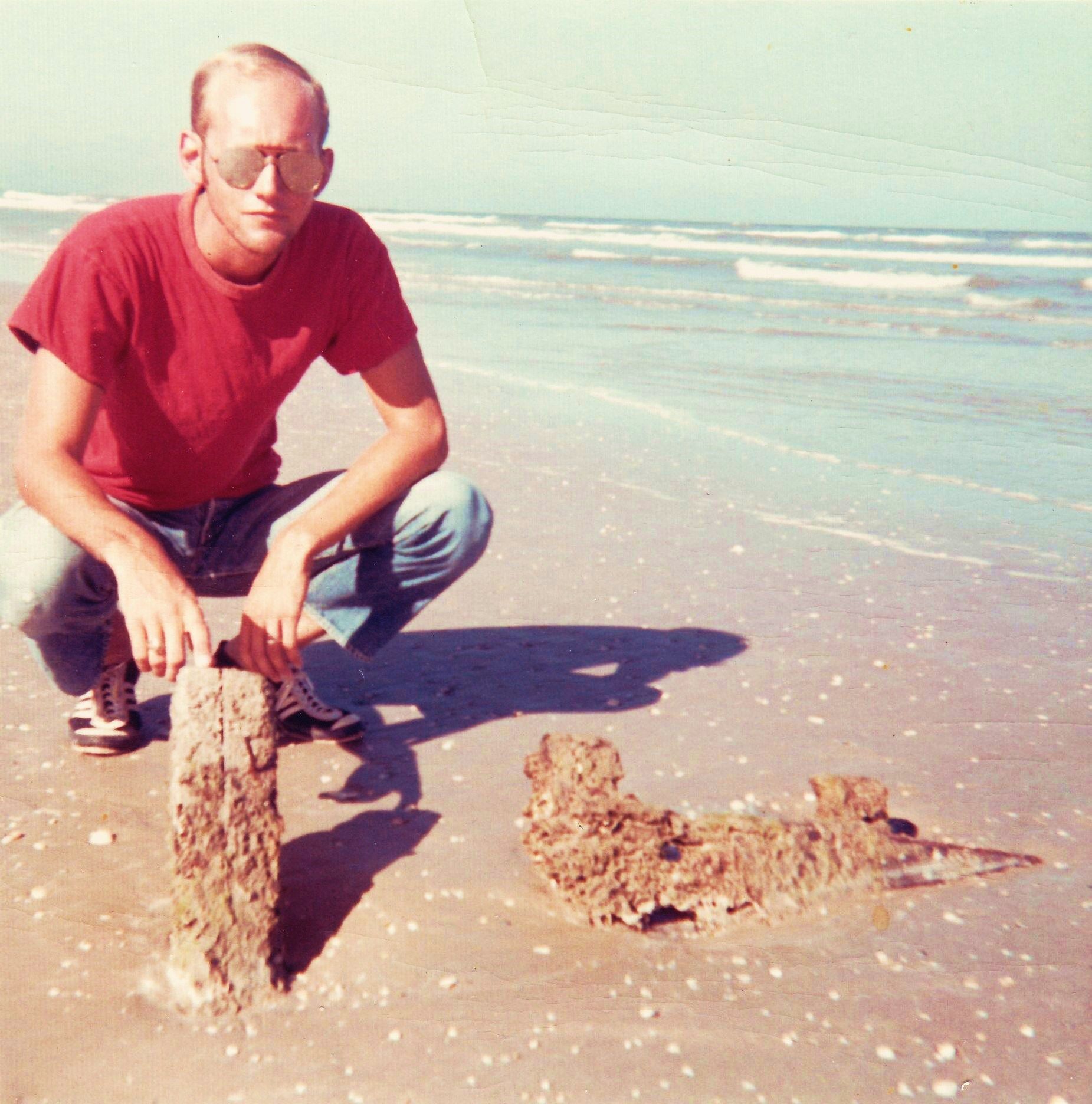 1969 me at North Padre Island Texas - wood shipwreck timbers, 20 miles down island, age 22