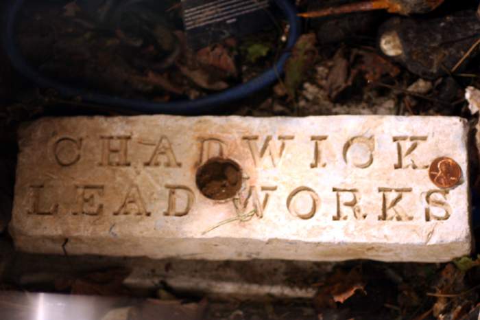 Chadwick lead Ingot - 30lb, Found 3 counterfeit lead coins, and lead buttons nearby.
 Ingot is from Chadwick Lead Mills in Salem Ma.
found in Portsmou