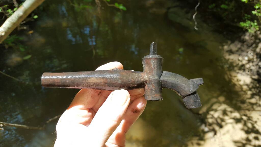 Complete 18th century keg tap; the long tapered end would have been hammered into an oak barrel containing ale or rum.   I found this in a creek that 