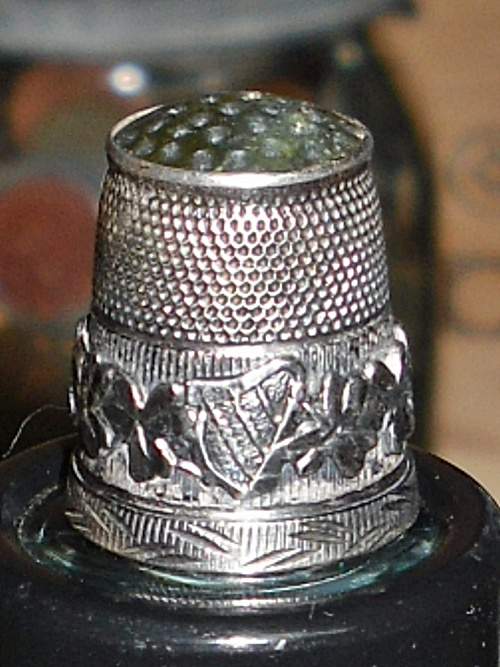 English Silver Thimble - 1907 - This sterling silver thimble was manufactured by James Swann. It features a green agate stone top with a dimpled main 