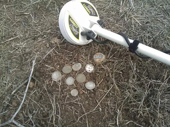 Garrett sniper find - this was a small cache of a few quarters,nickels and dimes all found insde of that bottle cap. only i quarter was outside the ca