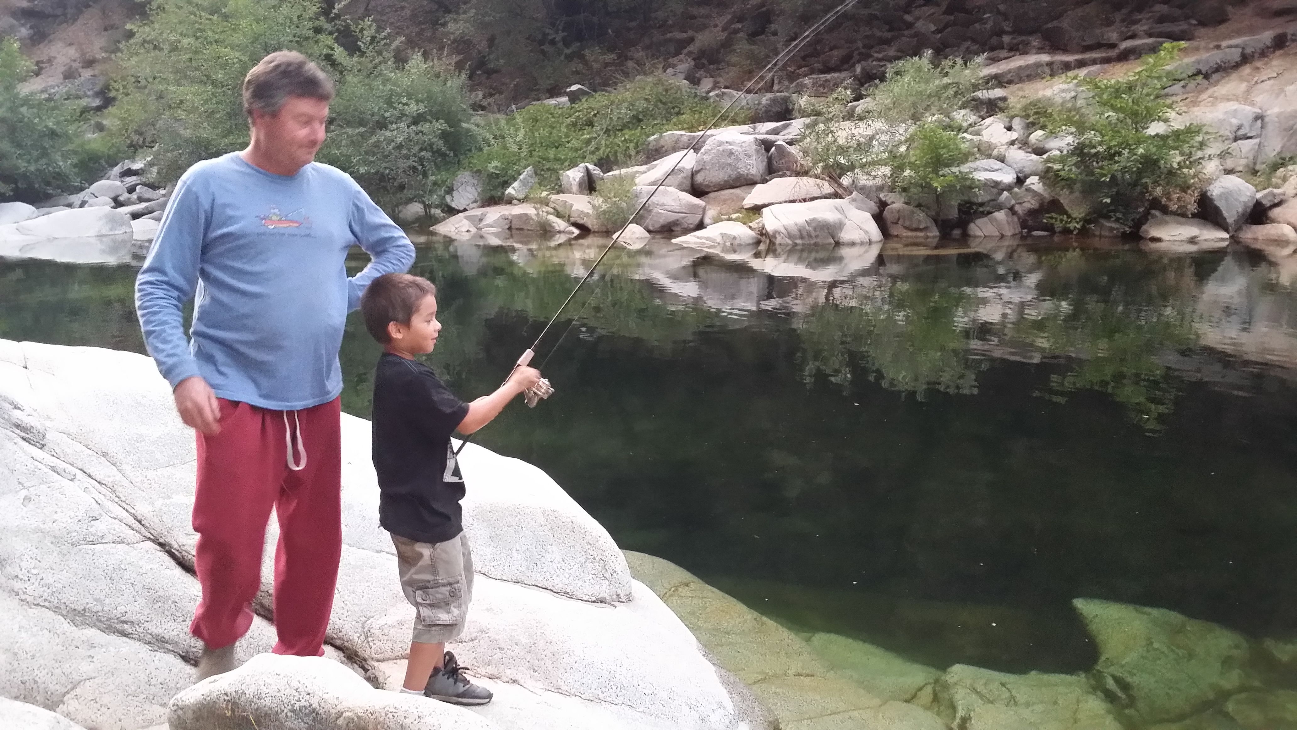 Grandson Ryden learning to fish from Rodney