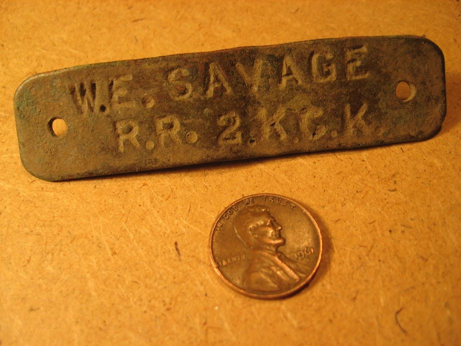 Hand-stamped brass tag found on former farm site in eastern KS (front).