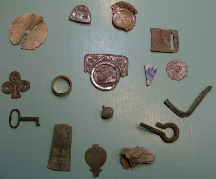 My favorite relics of 2009.   - From the 8 o'clock position, going clockwise: a small clock or cupboard key, an early brass furniture decoration, the 