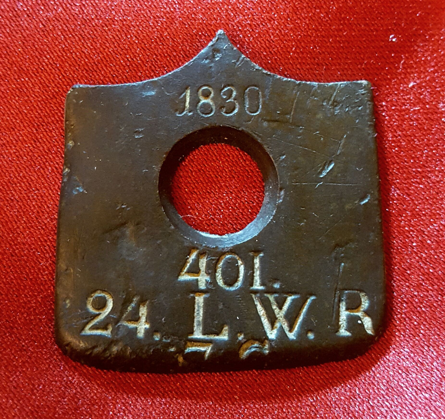 Partial butt plate from a Prussian musket.  Issued in 1830 to a Prussian soldier (in Germany) in the 24th Landweir Regiment (7th Company); repurposed 