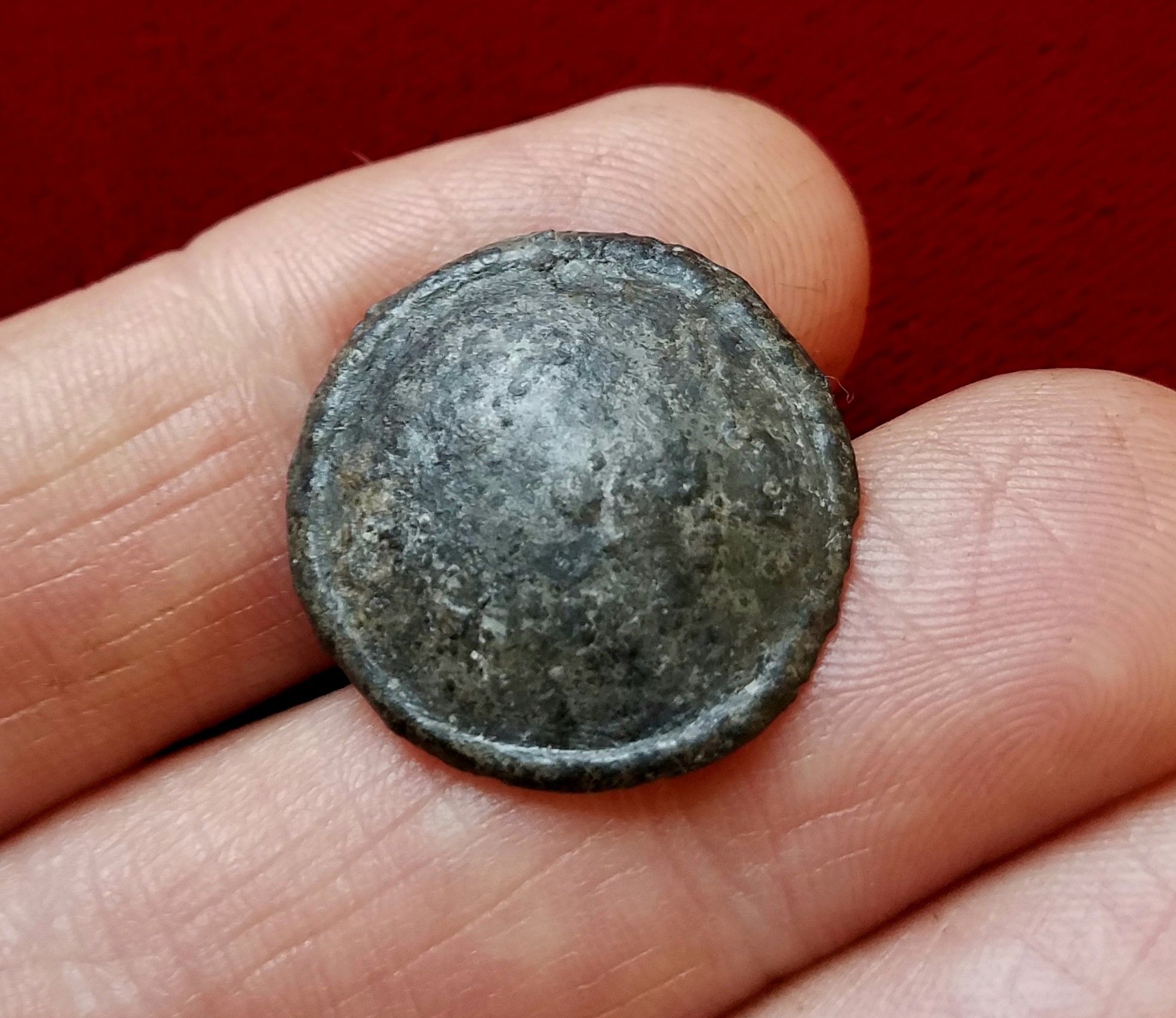 Pewter coat button dug from a creek