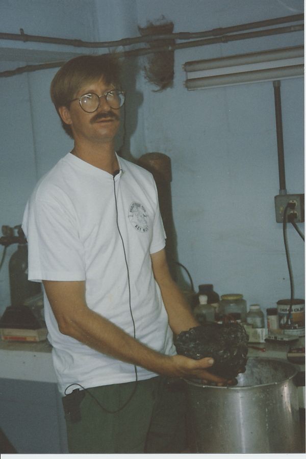 Syd Jones, holding a clump of a a thousand or so coins from an Atocha treasure chest.