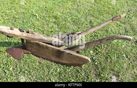 ancient-wooden-ancient-plow-over-meadow-kftpmx.jpg